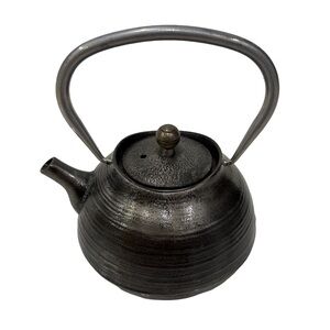 Black cast iron teapot with strainer